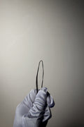 Close up of crochet hair structure against a solid neutral background