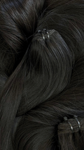 Close-up of straight black hair extensions with clips