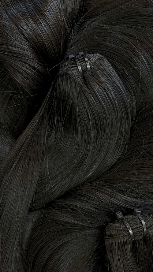 Close-up of straight black hair extensions with clips